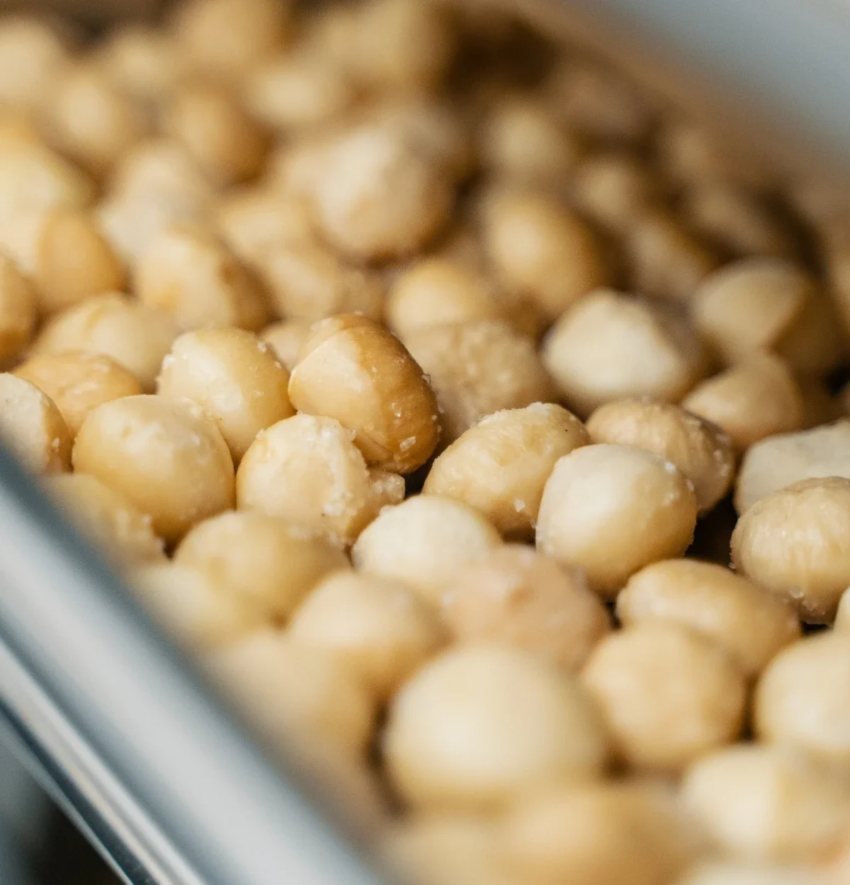 Detailaufnahme gesalzene Macadamia beim Roesten