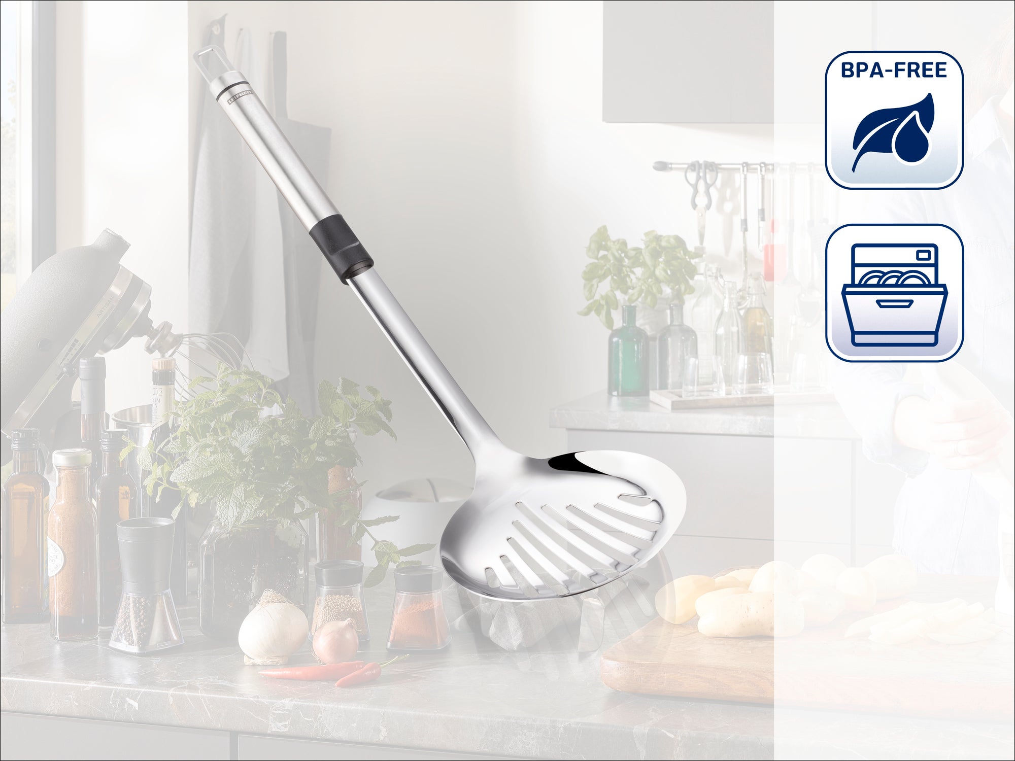A high-quality stainless steel slotted spoon lies on a kitchen worktop. Fresh ingredients and kitchen utensils can be seen in the background. The spoon is BPA-free and dishwasher safe.