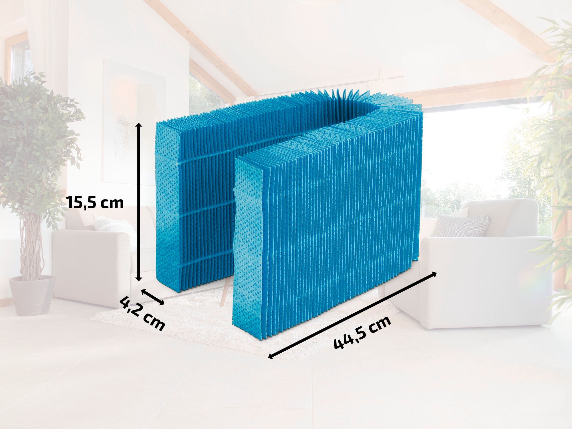 A blue air filter measuring 15.5 cm high, 42 cm wide and 44.5 cm deep stands in a bright room. The filter has a rectangular shape and is made of a fine, mesh-like material.