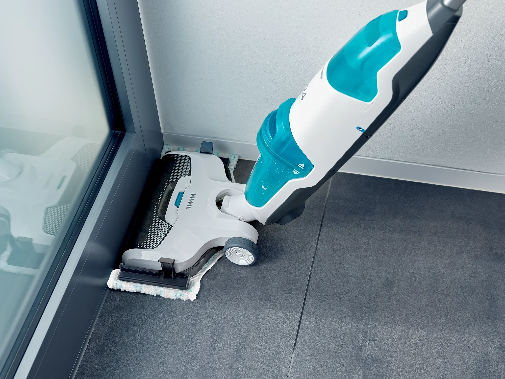 Odkurzacz Regulus Aqua PowerVac Pro w zbliżeniu, pokazujący jego funkcję czyszczenia narożników. Urządzenie w kolorze białym i niebieskim, idealne do trudno dostępnych miejsc.