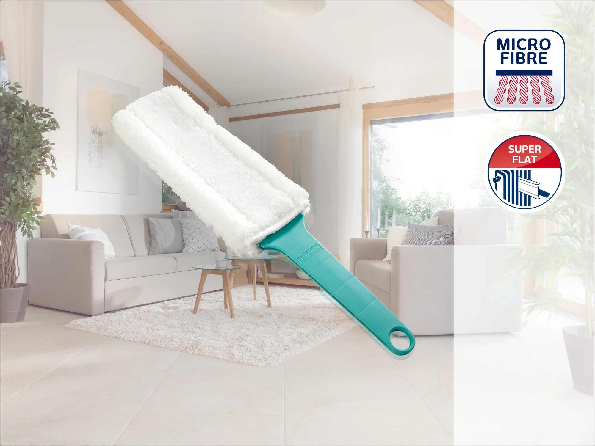 Een microvezel-stofmop met groene steel ligt in een moderne woonkamer met lichtgekleurde meubels. De foto toont de "Micro Fibre" en "Super Flat" kenmerken in de hoek.