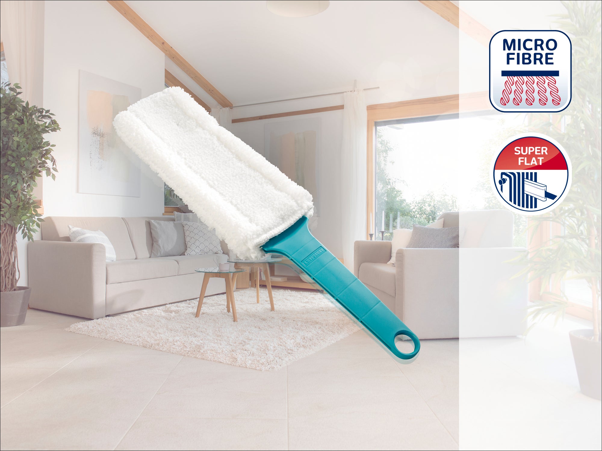 A microfibre dust mop with a green handle lies in a modern living room with light-coloured furniture. The image shows the "Micro Fibre" and "Super Flat" features in the corner.