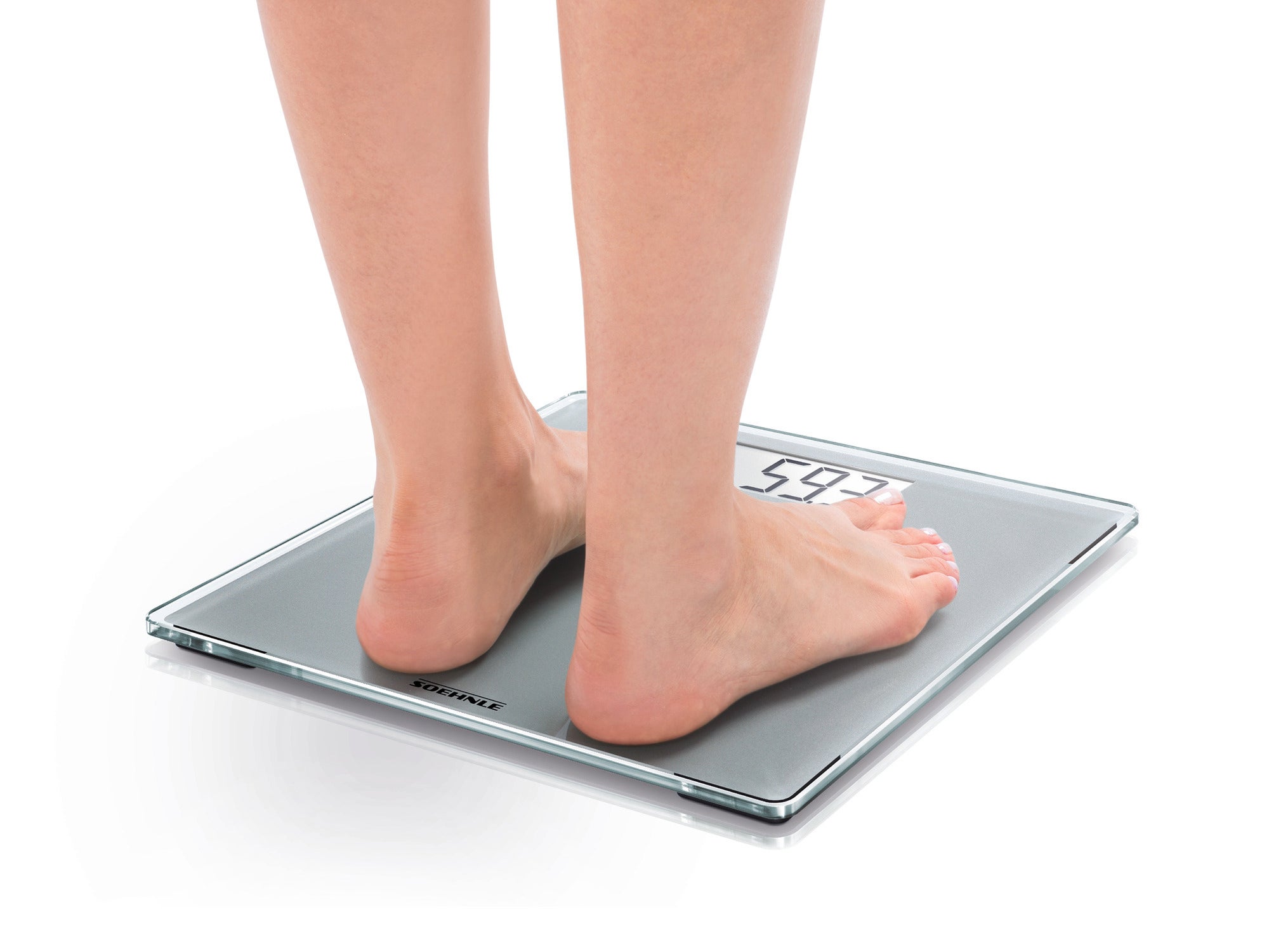A person stands barefoot on a digital bathroom scale, model Style Sense Compact 300. The scale displays the weight on an easy-to-read display. Ideal for precise weight measurements.