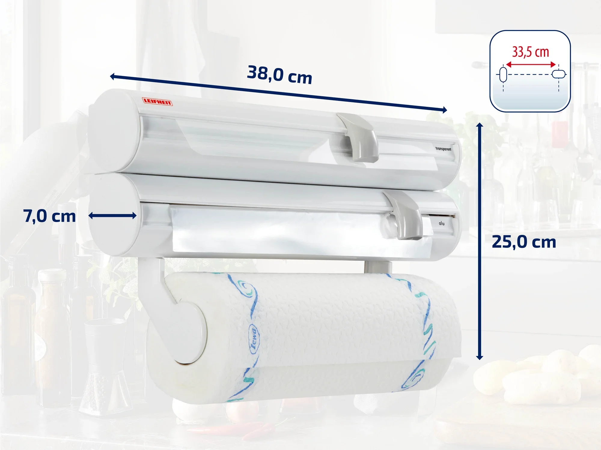 Naścienny uchwyt na rolki firmy Leifheit z trzema uchwytami na folię i rolki kuchenne. Wymiary: 38 cm szerokości, 25 cm wysokości, 7 cm głębokości. Praktyczny w kuchni do przechowywania folii i rolek papieru.
