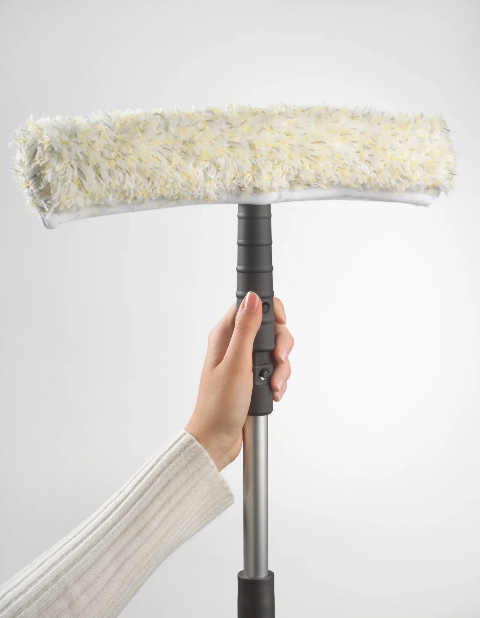 Met één hand houdt u een professionele schrobberhoes met een breedte van 45 cm vast. De overtrek is pluizig en ideaal voor het reinigen van grote glazen oppervlakken.