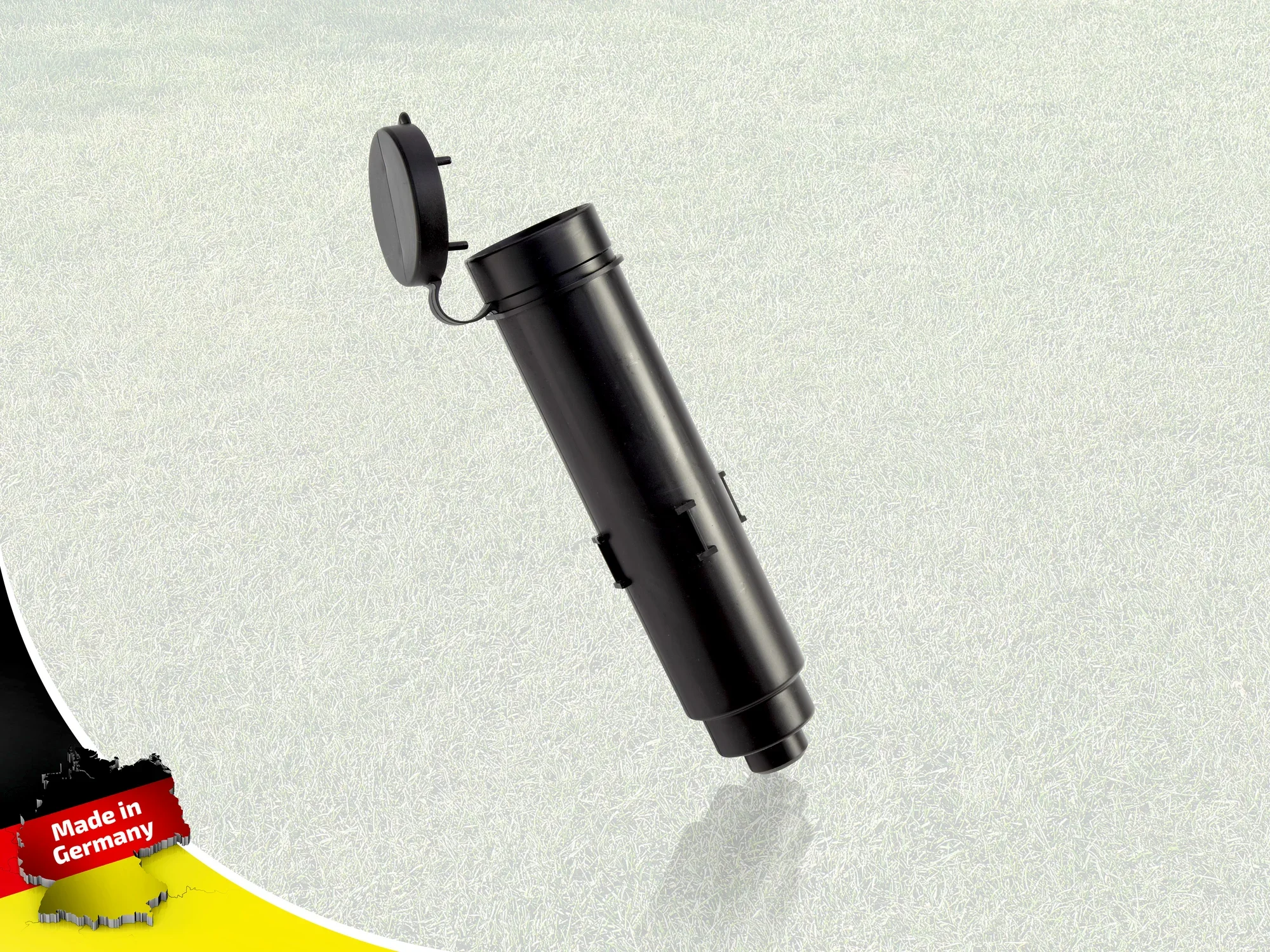 Czarna kotwa gruntowa do suszarek obrotowych, stojąca na jasnej powierzchni. Kotwa ma zdejmowaną pokrywę i jest oznaczona etykietą "Made in Germany".