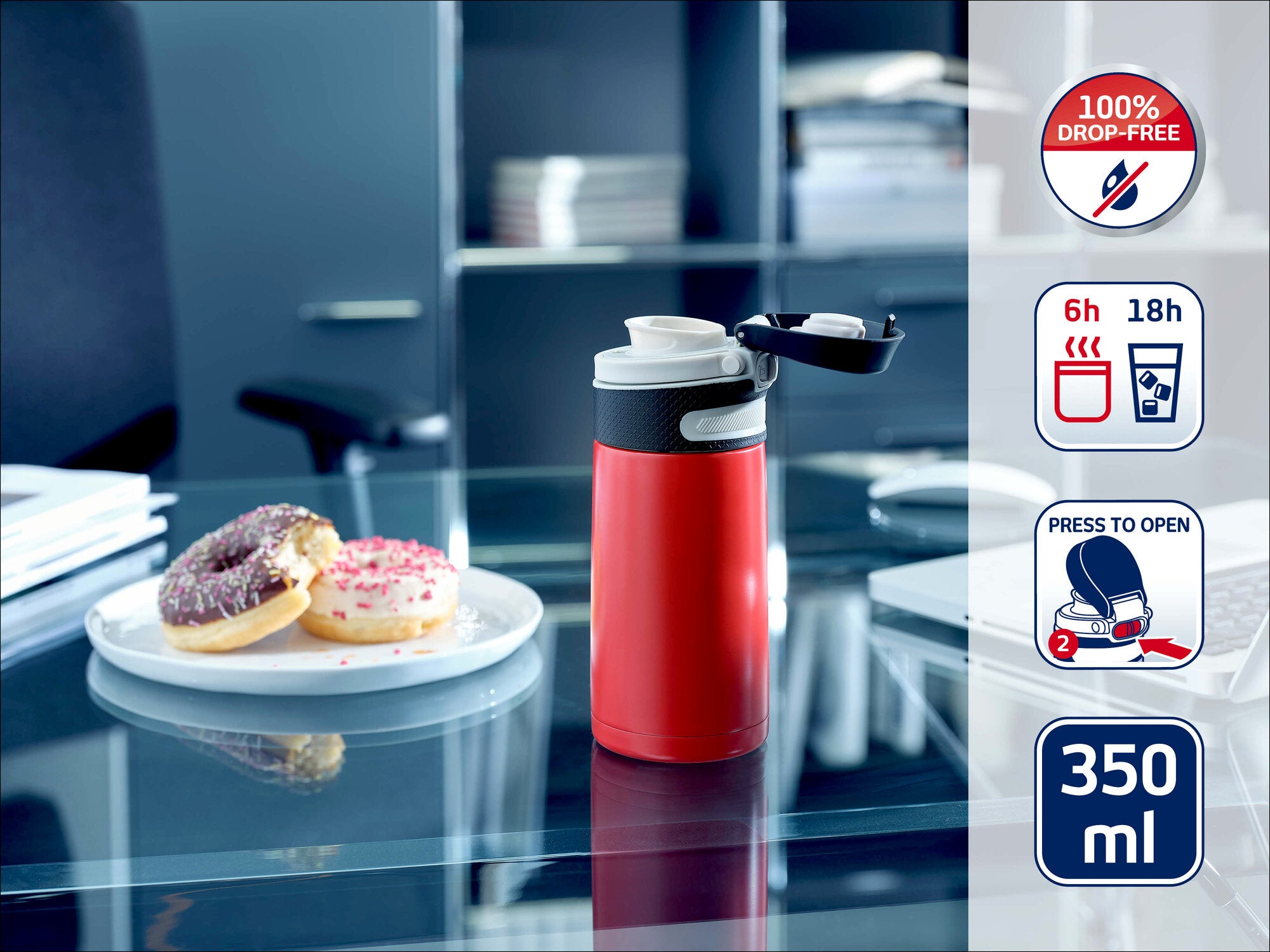 Leifheit Isolierbecher 350 ml in Rot mit schwarzem Deckel auf einem Glastisch im Büro; daneben ein Teller mit zwei Donuts. Symbole zeigen auslaufsicheres Design sowie 6 Stunden warm und 18 Stunden kalt.
