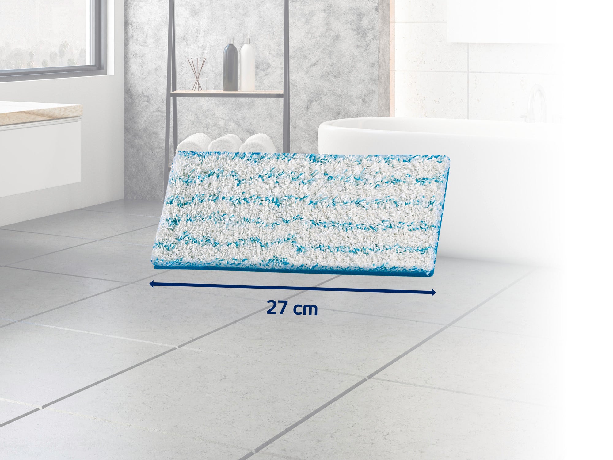 Prostokątna nakładka mopa z niebieskimi i białymi paskami leży na szarej podłodze wyłożonej kafelkami w łazience. Nakładka ma 27 cm szerokości i jest idealna do czyszczenia podłóg.