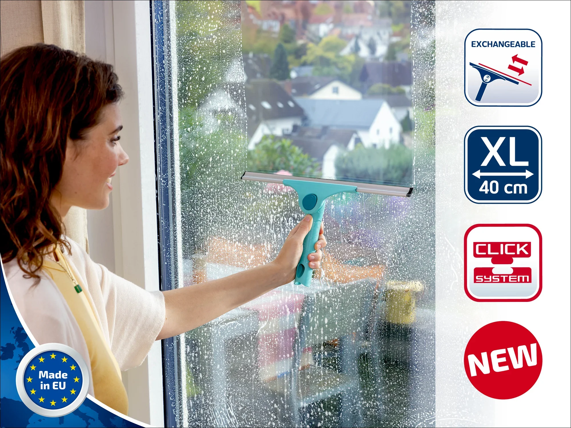A woman cleans a window with the Leifheit window squeegee. The product has an XL size of 40 cm and is part of the click system. Made in the EU.