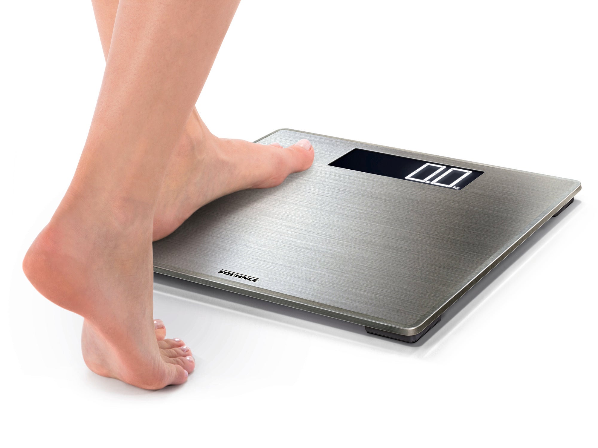 A person is standing on the Style Sense Safe 300 digital bathroom scale. The scale has an elegant silver surface and an easy-to-read display. Ideal for precise weight measurements.