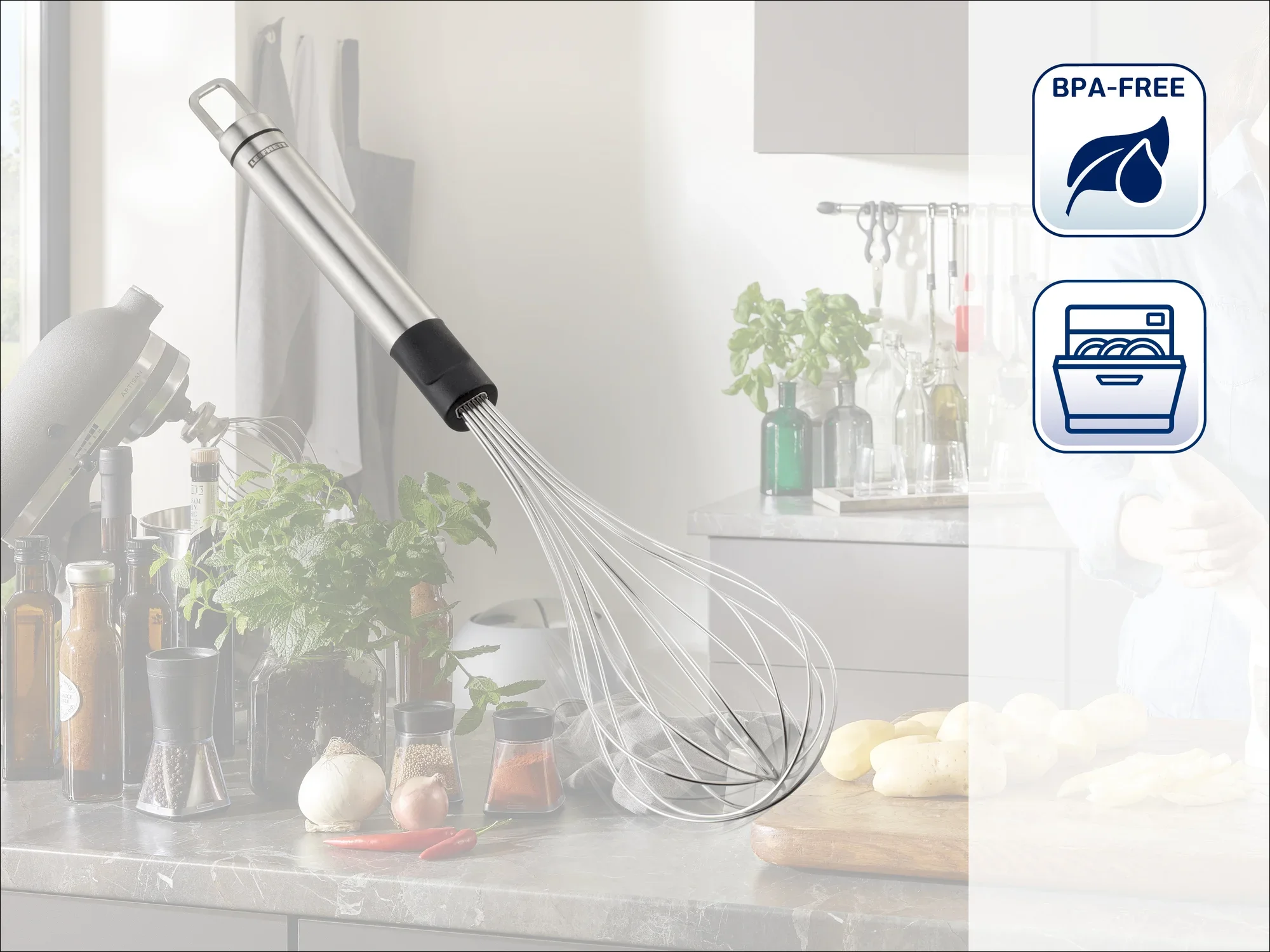 A stainless steel whisk hangs in a modern kitchen. Fresh ingredients and kitchen utensils can be seen in the background. Symbols indicate that it is BPA-free and dishwasher safe.