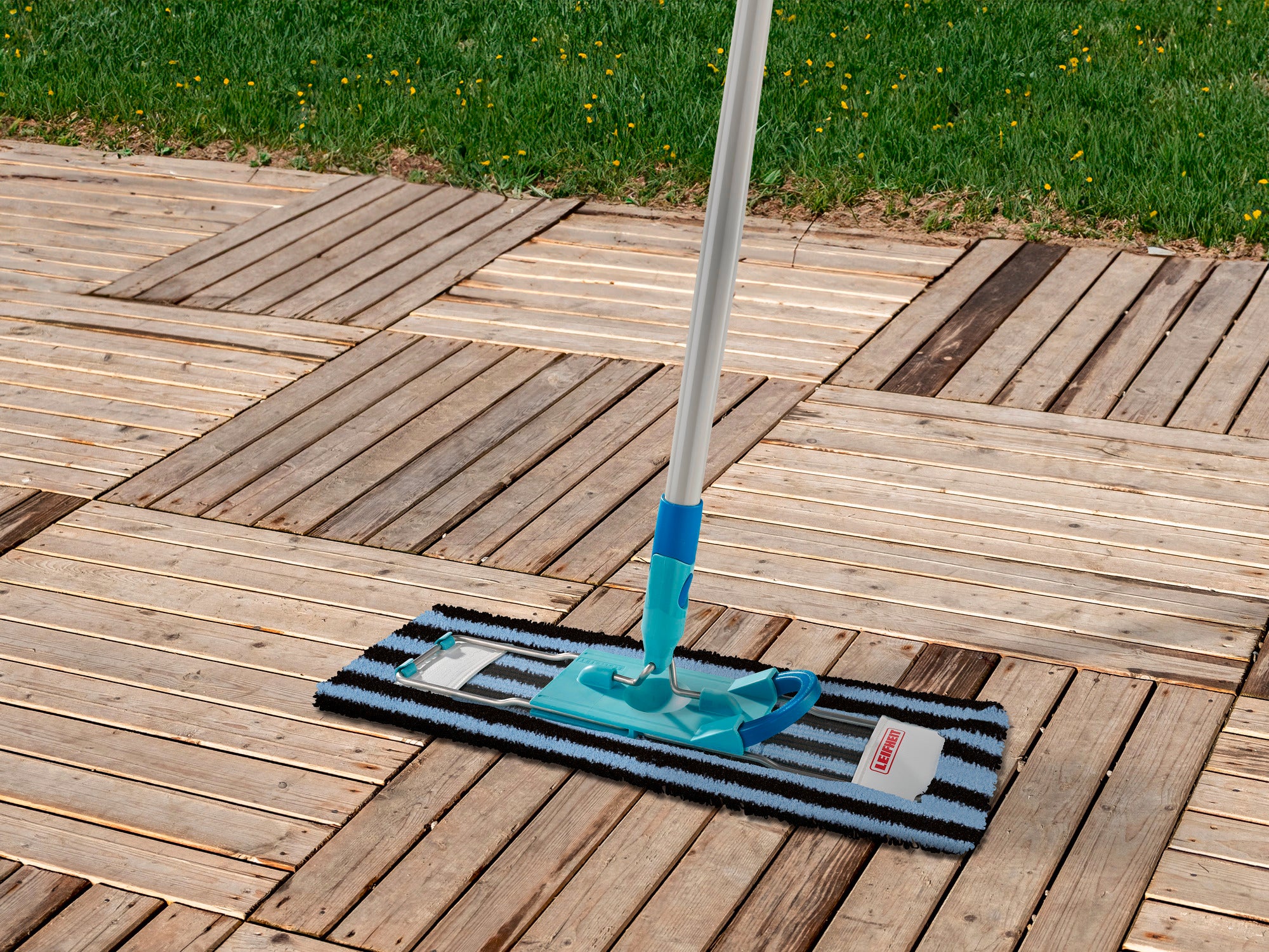 Profi XL Outdoor mopovertrek op een houten terras. De overtrek is blauw en zwart gestreept en wordt gebruikt met een steel. Ideaal voor het schoonmaken van buitenruimtes.