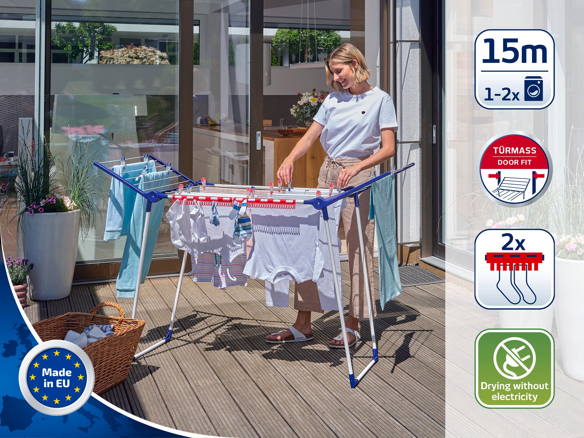 A woman is standing on a terrace using a free-standing dryer to dry laundry. The dryer offers 15 metres of drying space and does not require electricity. Ideal for outdoor use.