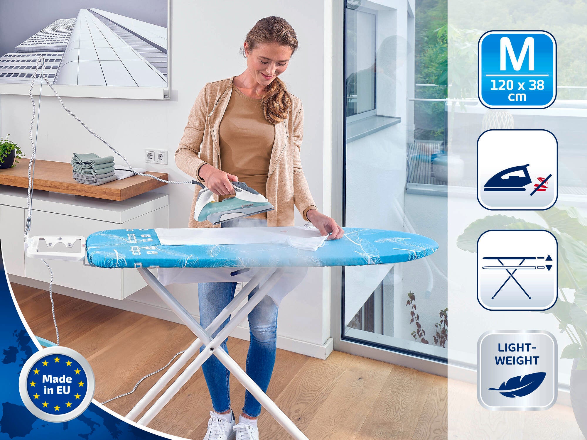 A woman is ironing on a blue ironing table in a modern room. The table is lightweight and measures 120 x 38 cm. Symbols indicate that it is steam-permeable and made in the EU.