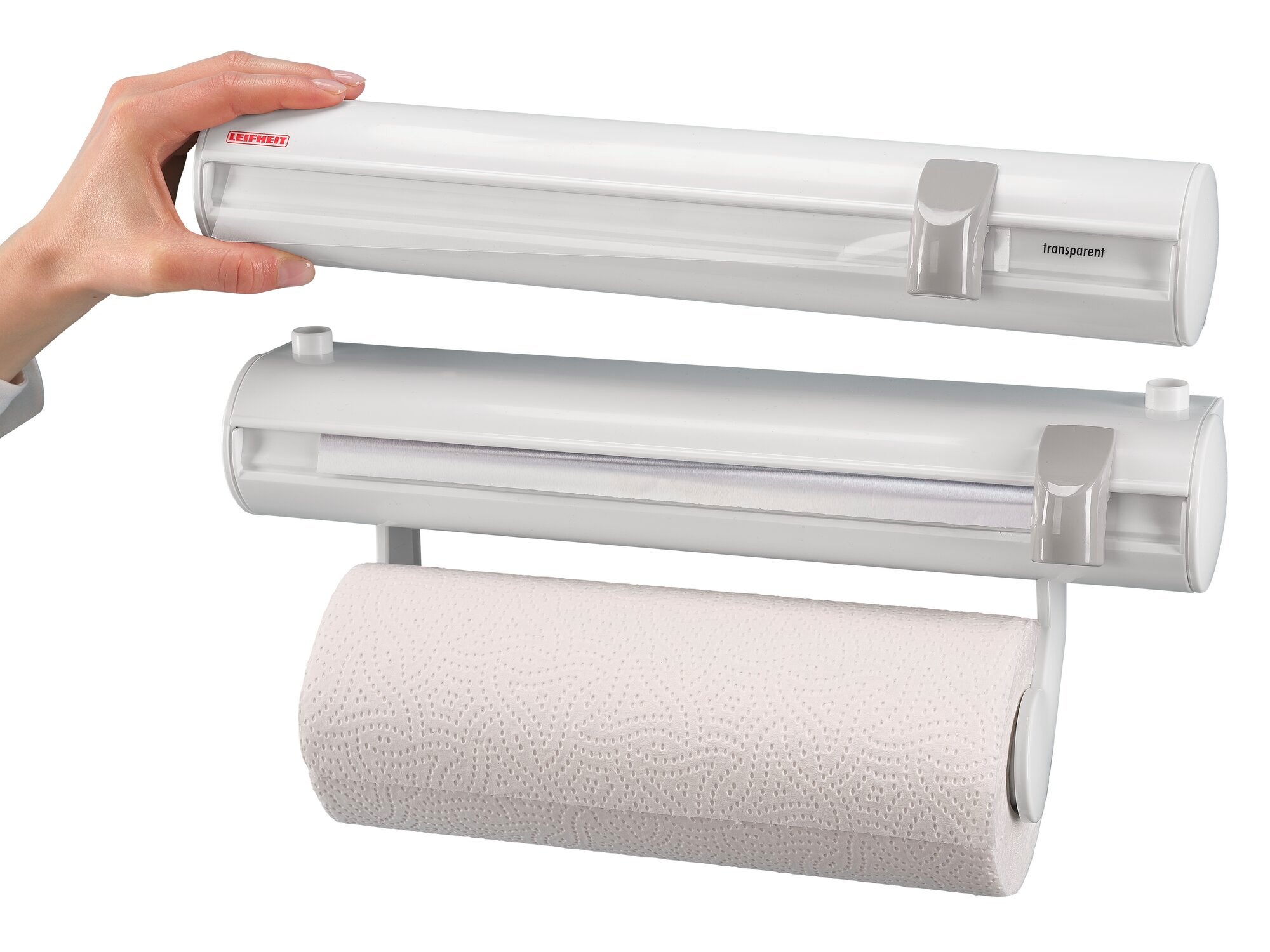 Wandrollenhalter Rolly Mobil: Ein weißer Wandrollenhalter mit einer Papierrolle, die einfach eingesetzt werden kann. Eine Hand zeigt die einfache Handhabung des Produkts.