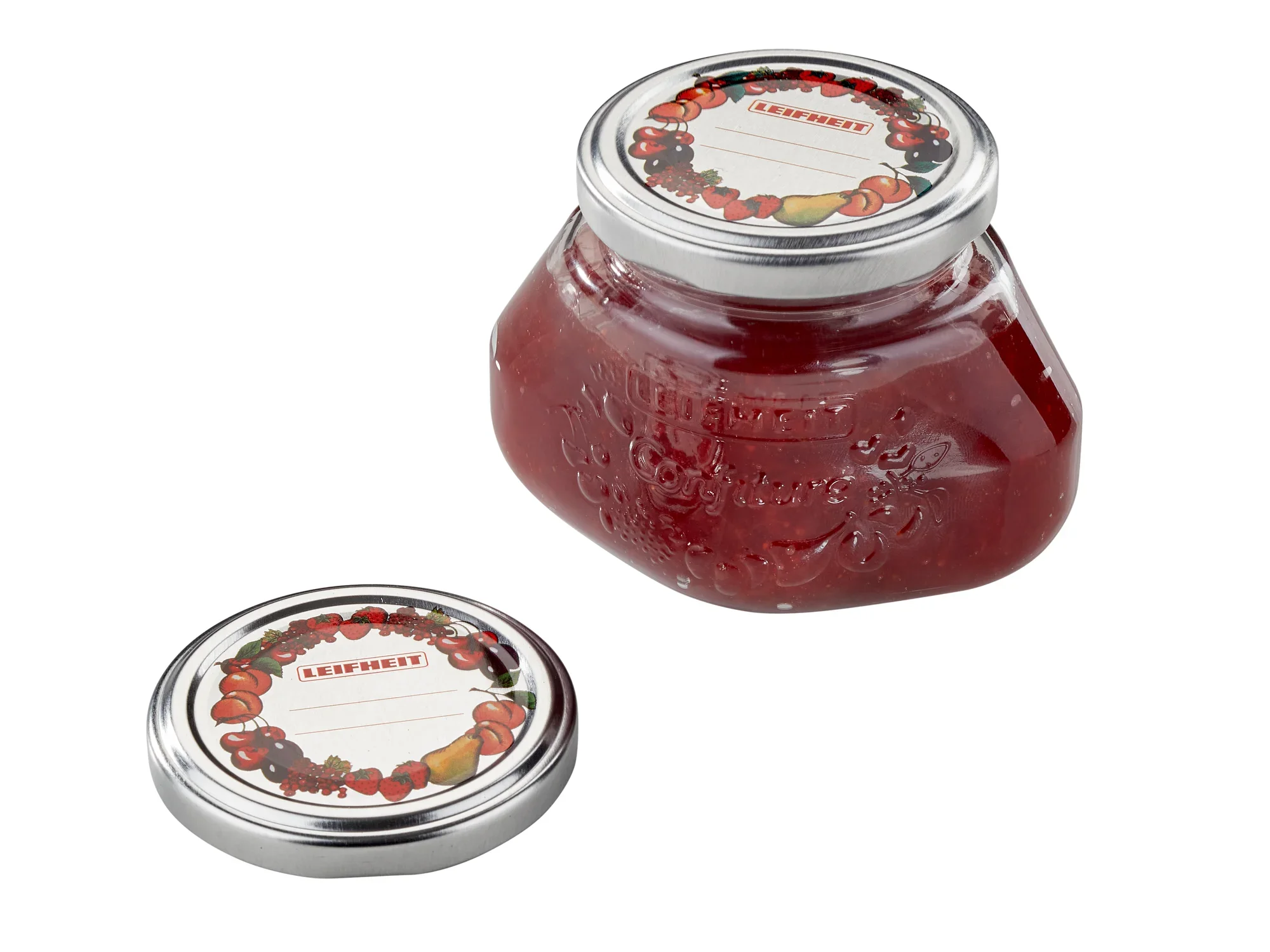 Wymienna pokrywka 66 mm: Słoik z czerwoną zawartością i zdjętą pokrywką. Pokrywka ma dekoracyjny wzór owoców. Idealny na dżemy i marmolady.