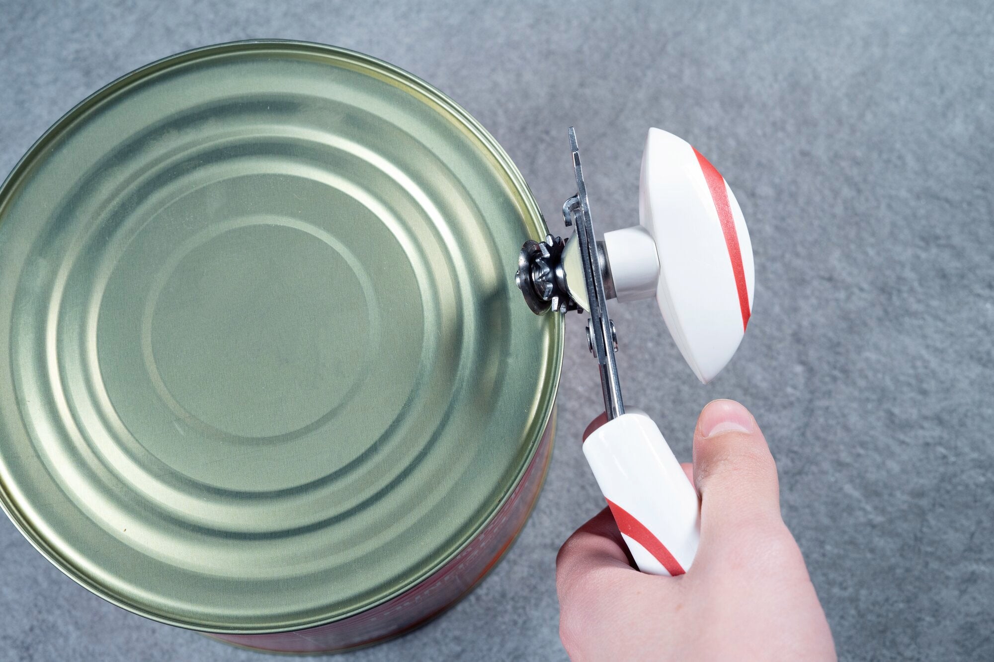 A can opener called "Lifty" is used to open large tin cans. The ergonomic handle and sharp blade make it easy to open the can.