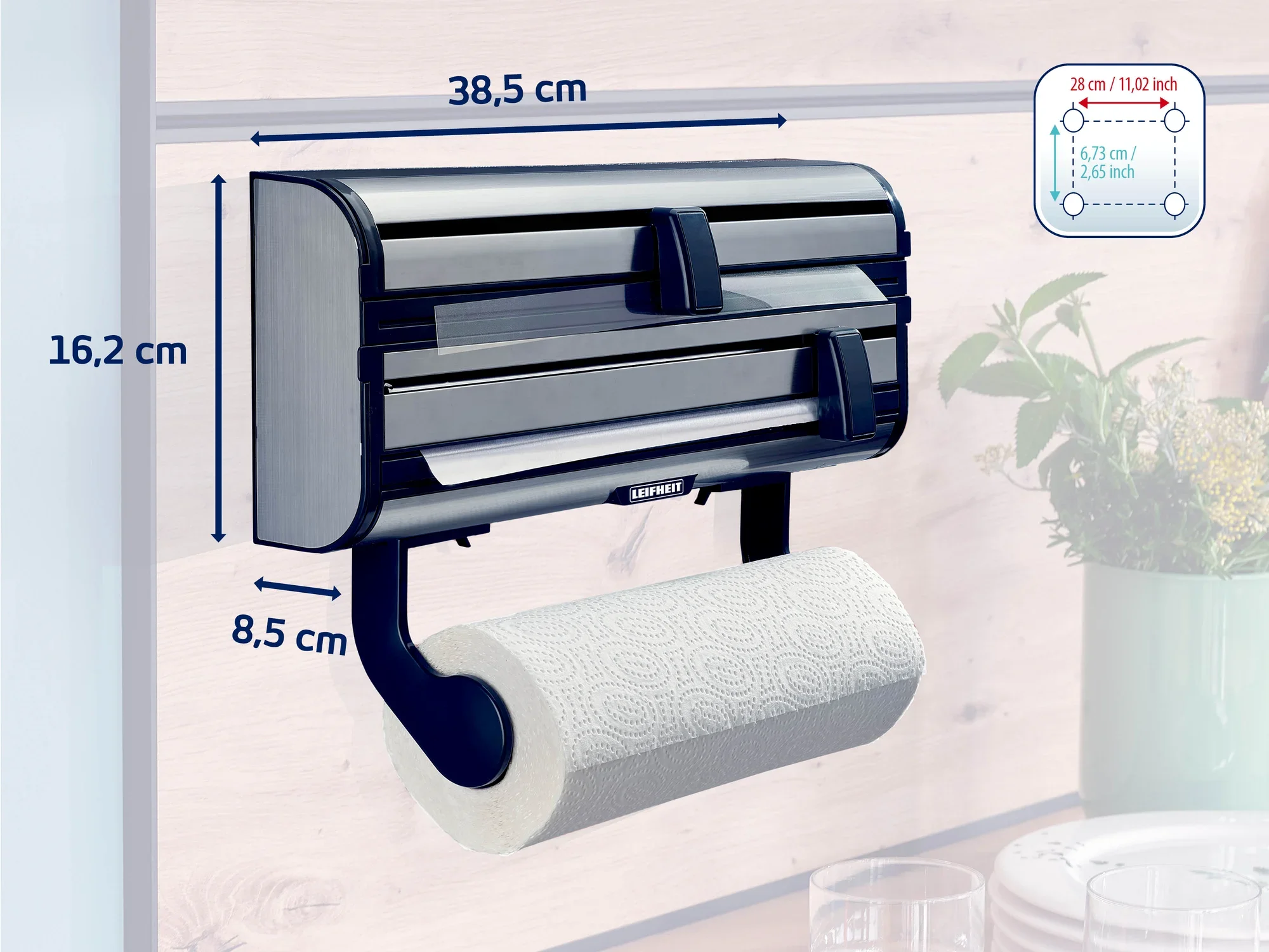 Naścienny uchwyt na rolki Leifheit z trzema przegrodami na rolki folii i papieru. Wymiary: 38,5 cm szerokości, 16,2 cm wysokości, 8,5 cm głębokości. Praktyczny w kuchni i gospodarstwie domowym.
