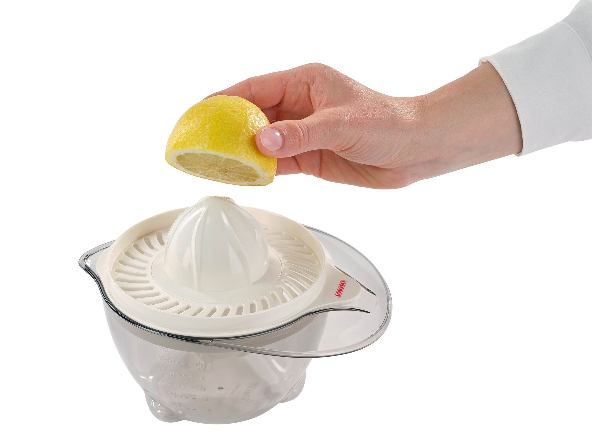 A hand holds half a lemon over a citrus press. The press has a transparent collection container and a white press cone. Ideal for juicing citrus fruits.