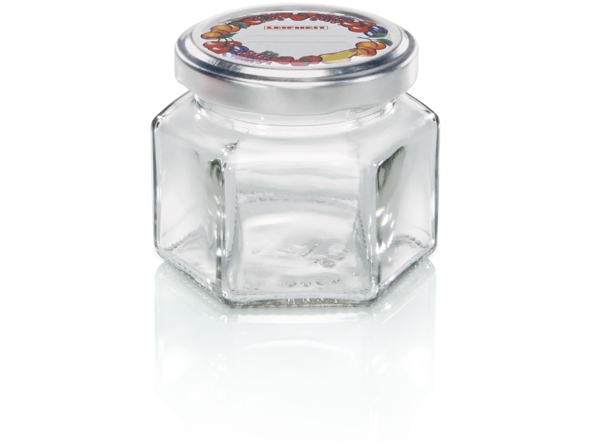 Pot hexagonal d'une contenance de 106 ml. Le pot a une forme hexagonale et un couvercle argenté avec un motif de fruits colorés. Idéal pour les confitures ou les épices.