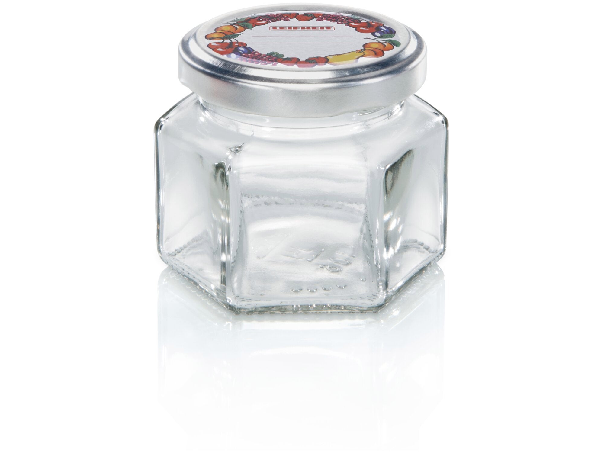 Sechskantglas mit einem Fassungsvermögen von 106 ml. Das Glas hat eine sechseckige Form und einen silbernen Deckel mit buntem Fruchtmotiv. Ideal für Marmeladen oder Gewürze.