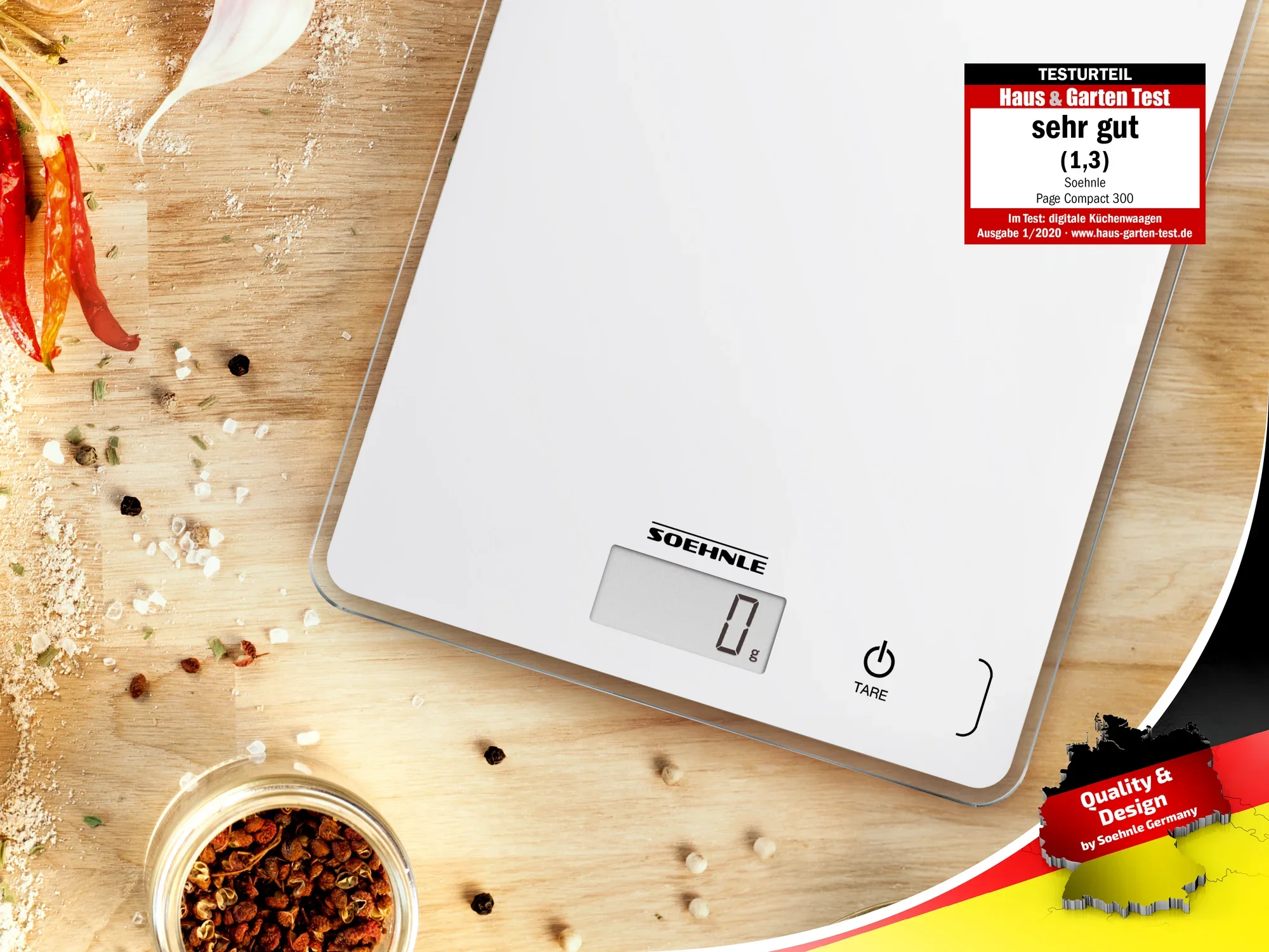 Soehnle Page Compact 300 kitchen scales in white on a wooden table with spices. The scales display 0 g and have been awarded a "very good" rating by Haus & Garten Test.