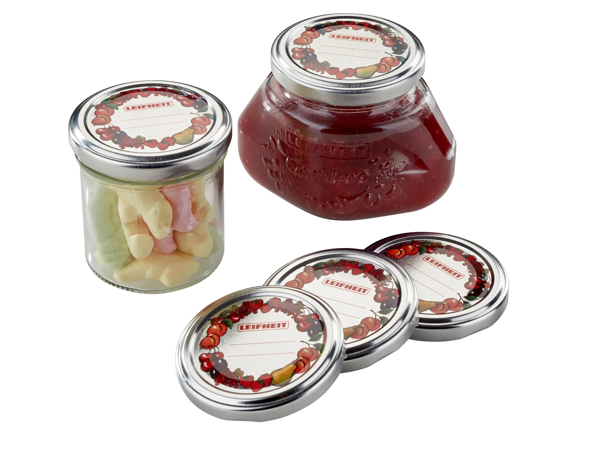 Wymienne pokrywki 66 mm: Trzy srebrne wymienne pokrywki obok słoika z czerwonymi owocami i słoika z kolorowymi słodyczami. Idealne do przechowywania żywności.